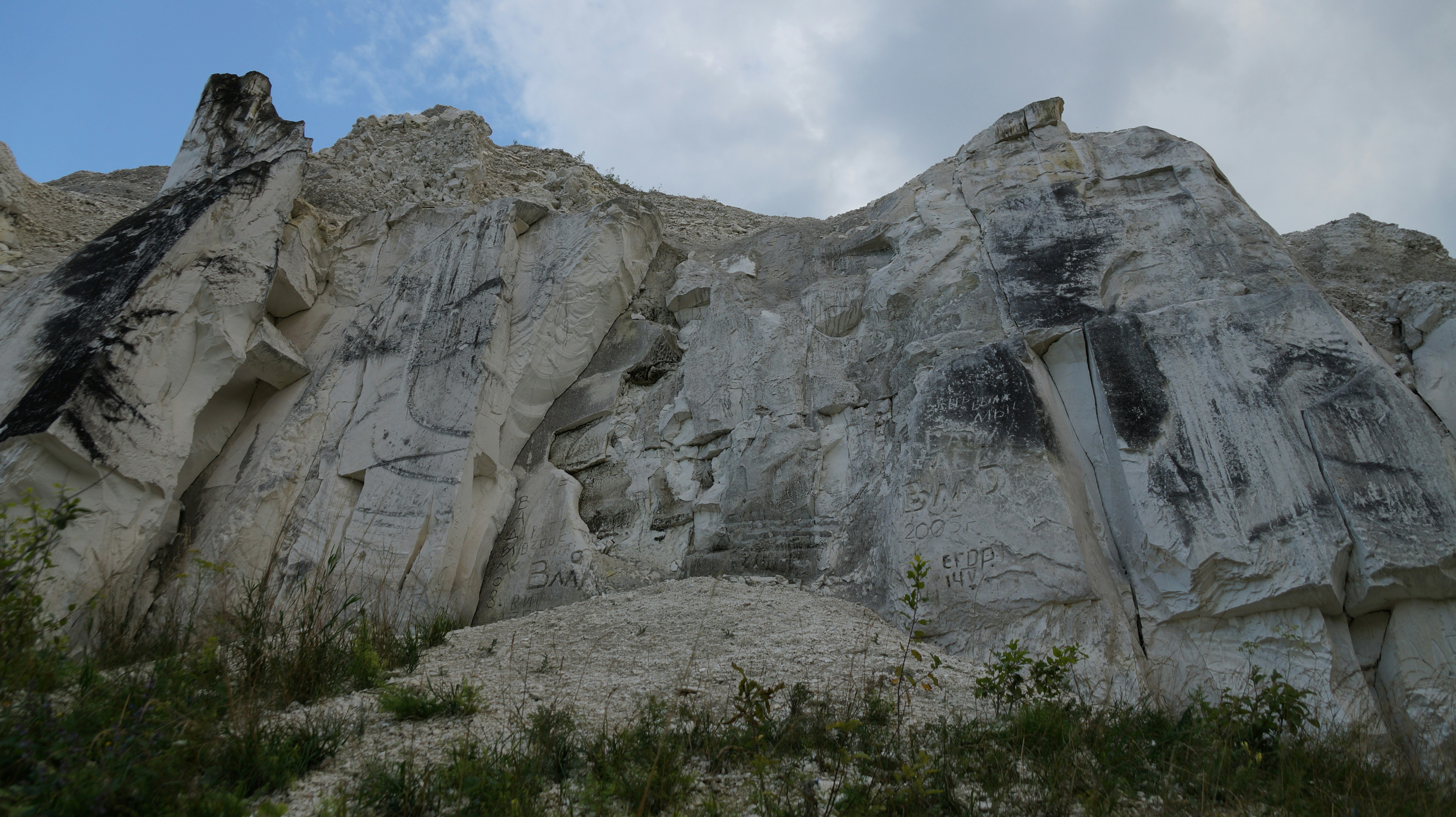 a large rock formation with a sky in the background