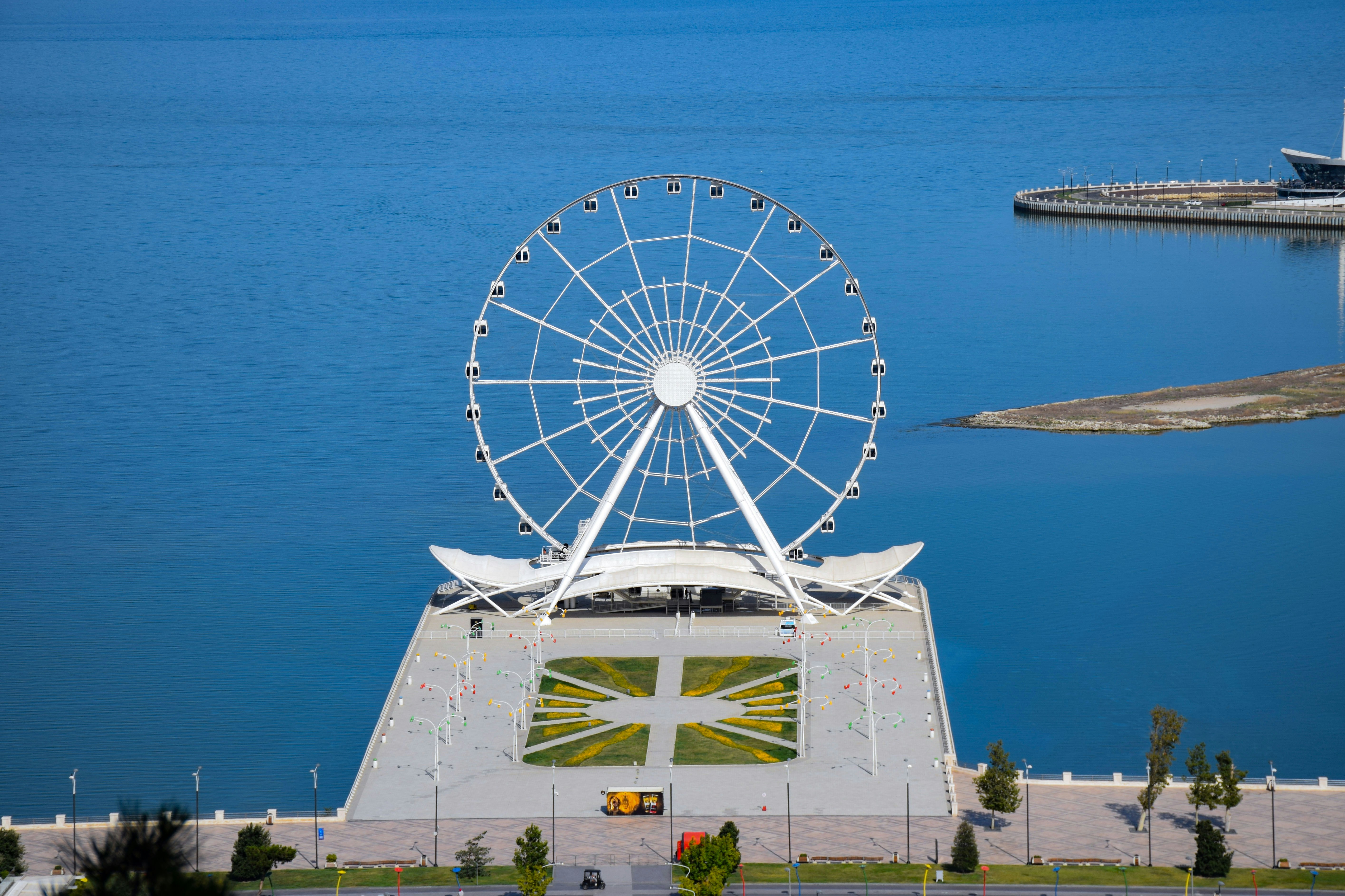 a large ferris wheel sitting next to a body of water