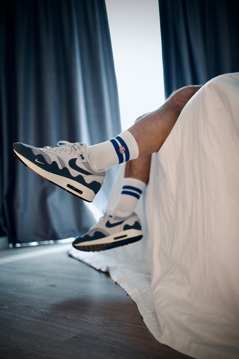 A person laying on a bed with their feet up photo – Free Sneaker Image on  Unsplash