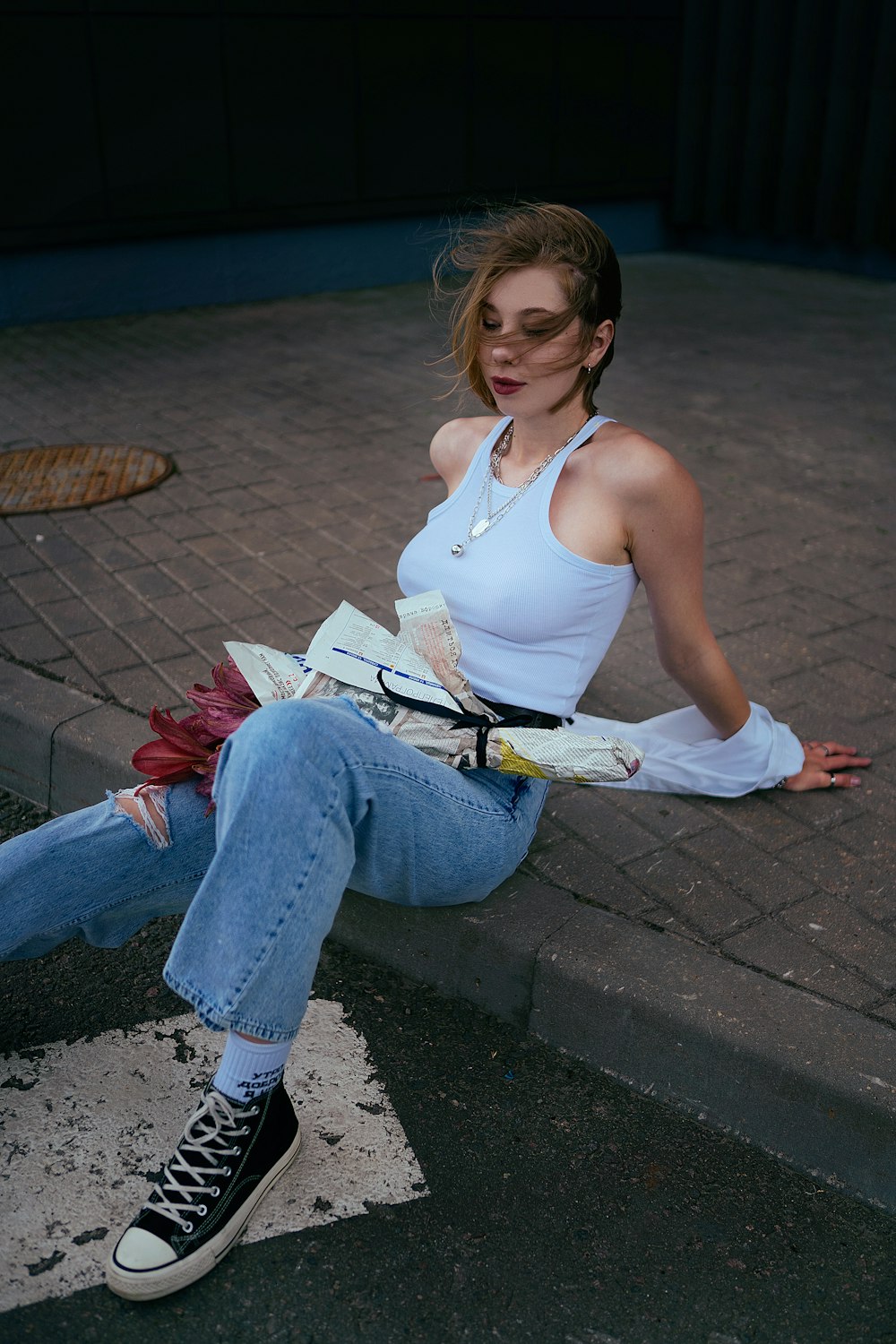 a woman sitting on the ground with a book