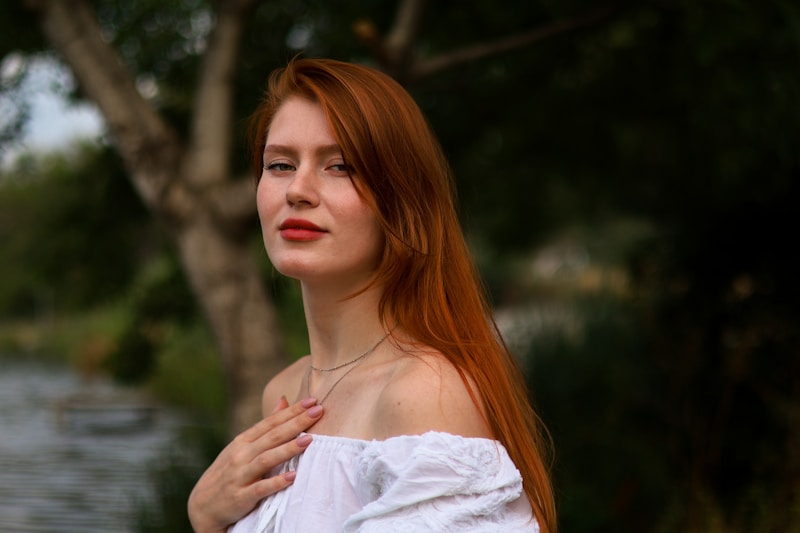 Woman with red hair by the water