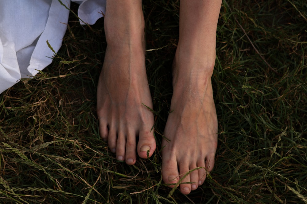 a woman's bare feet in the grass