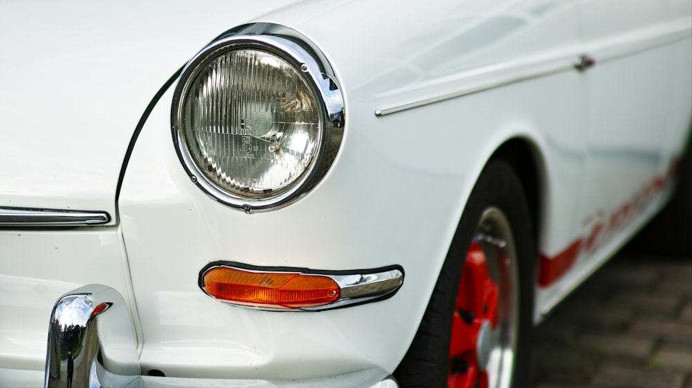 a close up of the front of a white car