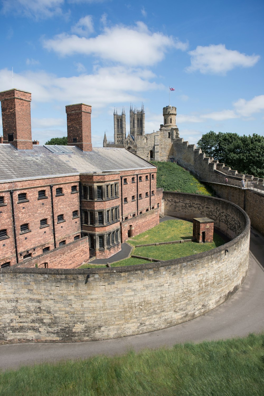 a large brick building with a green roof