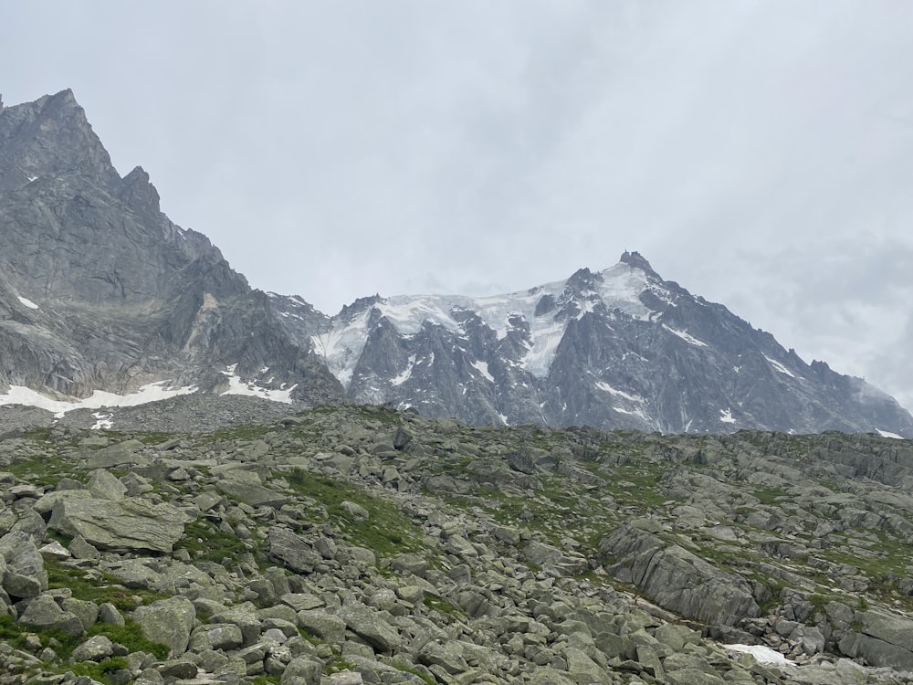 a mountain range covered in rocks and grass