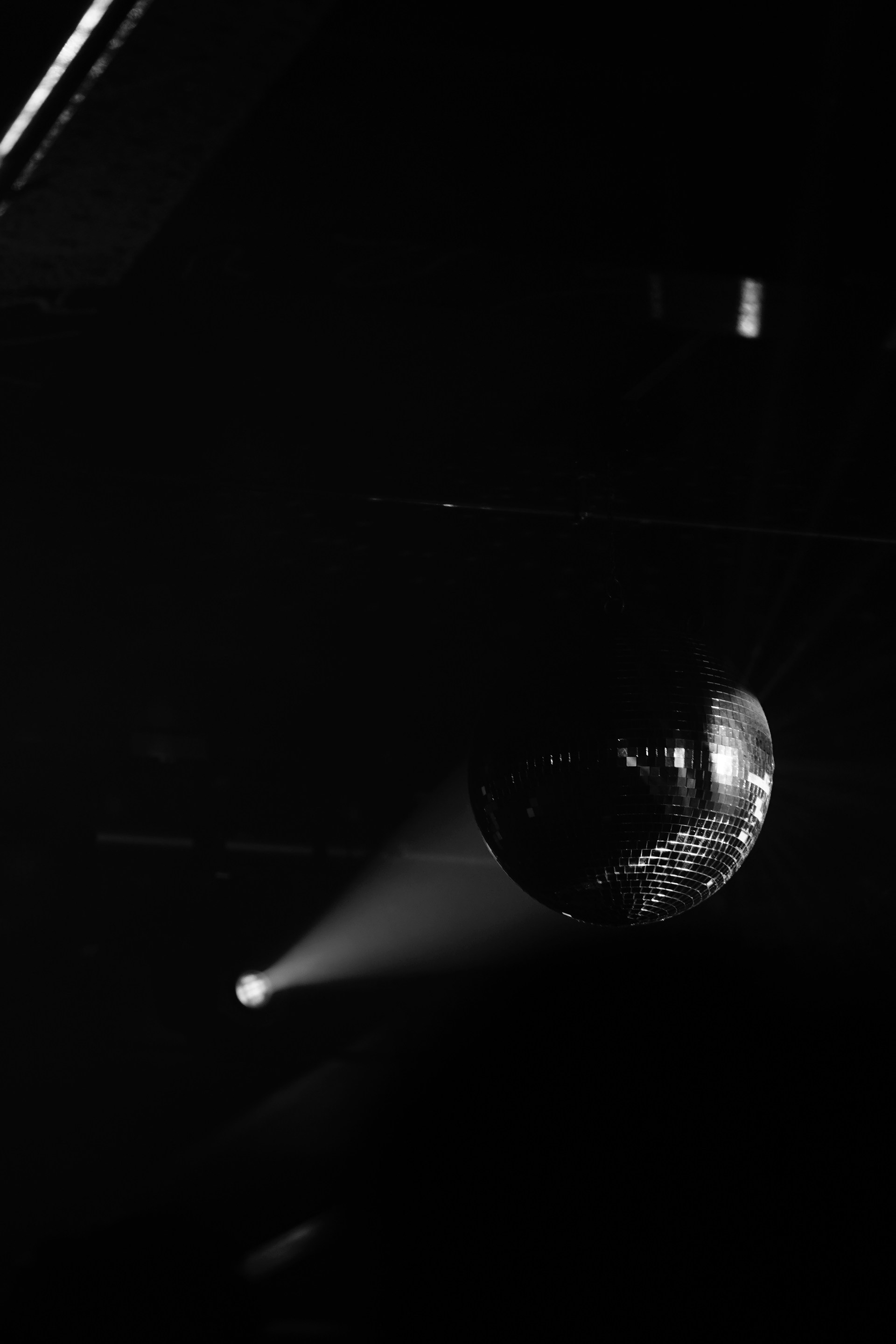 a disco ball hanging from a ceiling in a dark room