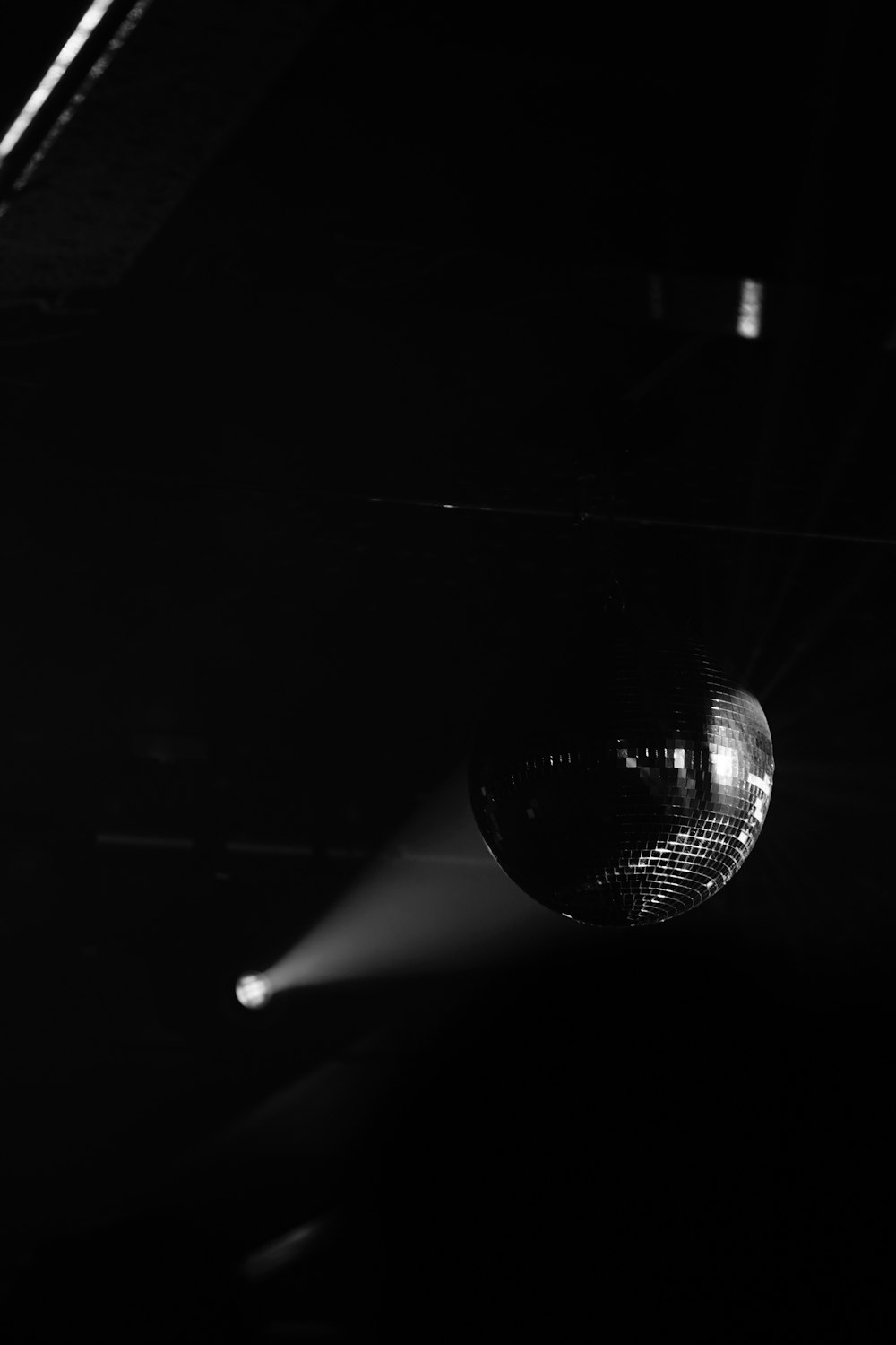 a disco ball hanging from a ceiling in a dark room