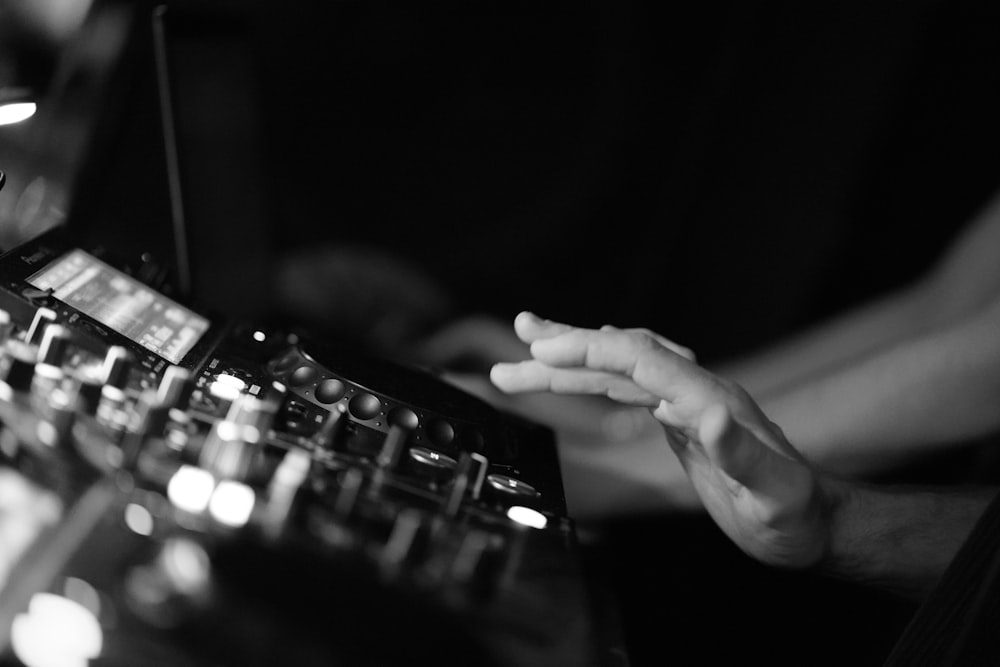 a person using a sound mixing console in a recording studio