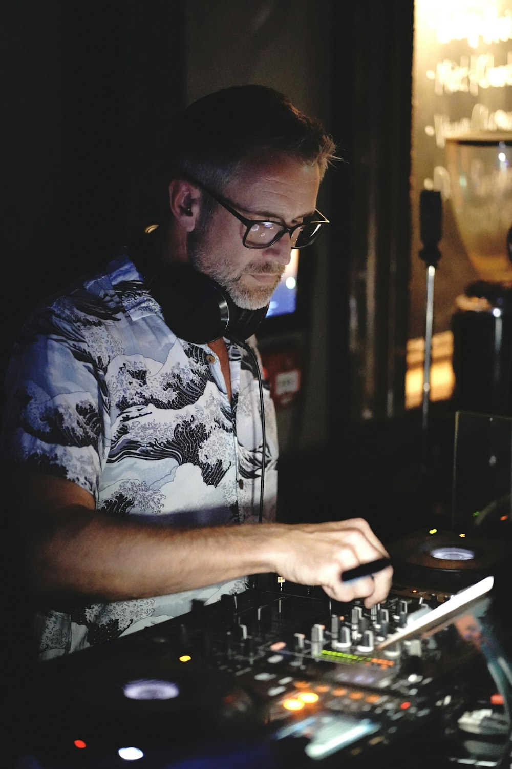 a man in a black and white shirt mixing music