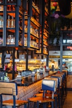 Friendly staff serving drinks at a lively bar counter in the restaurant.
