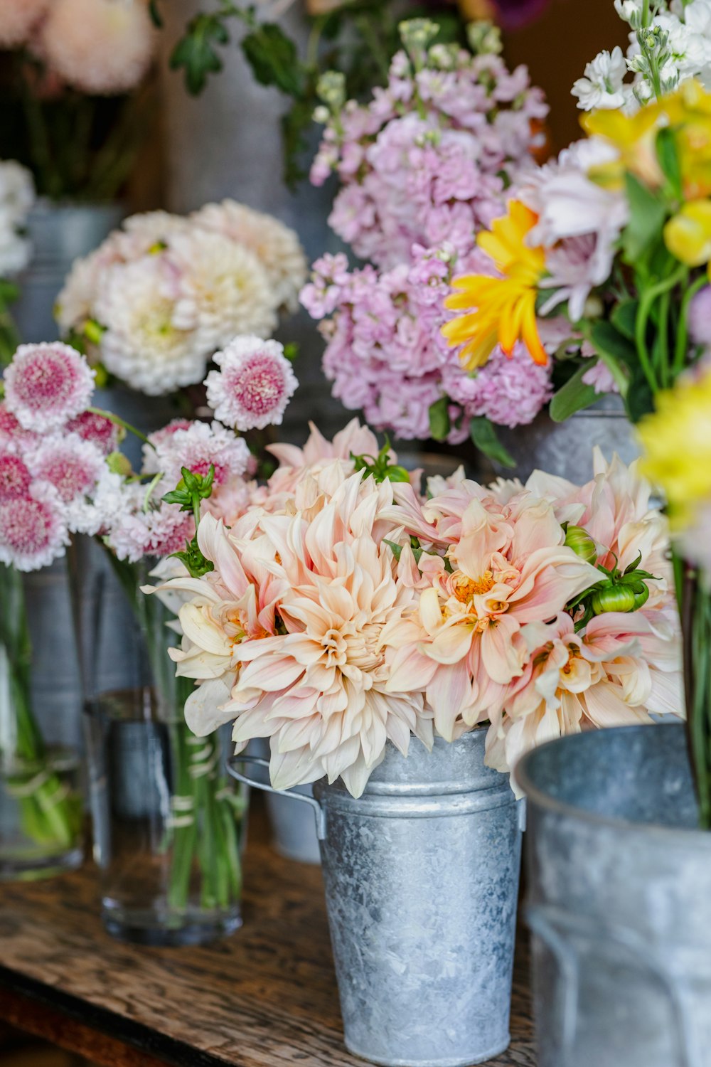 a bunch of flowers that are in vases