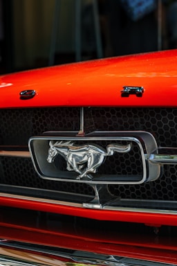 Close-up of a sleek 2007 Mustang GT front grille with a shining emblem.