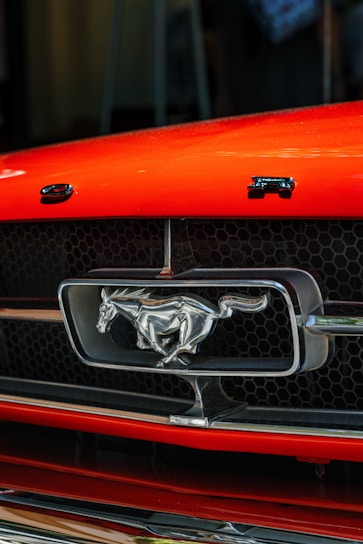 Close-up of a sleek 2007 Mustang GT front grille with a shining emblem.