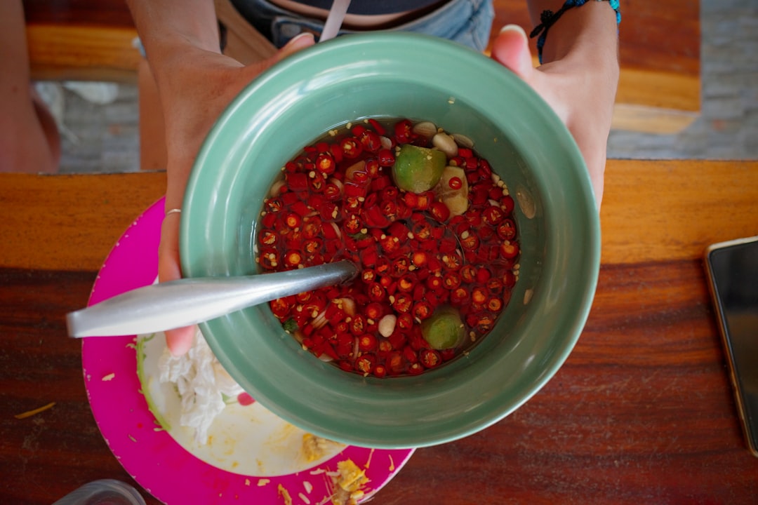 a person holding a bowl of food on a table,