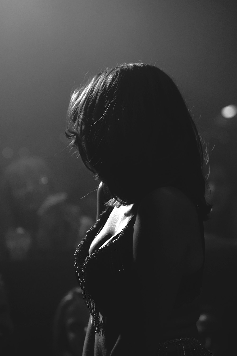 a black and white photo of a woman in a dress