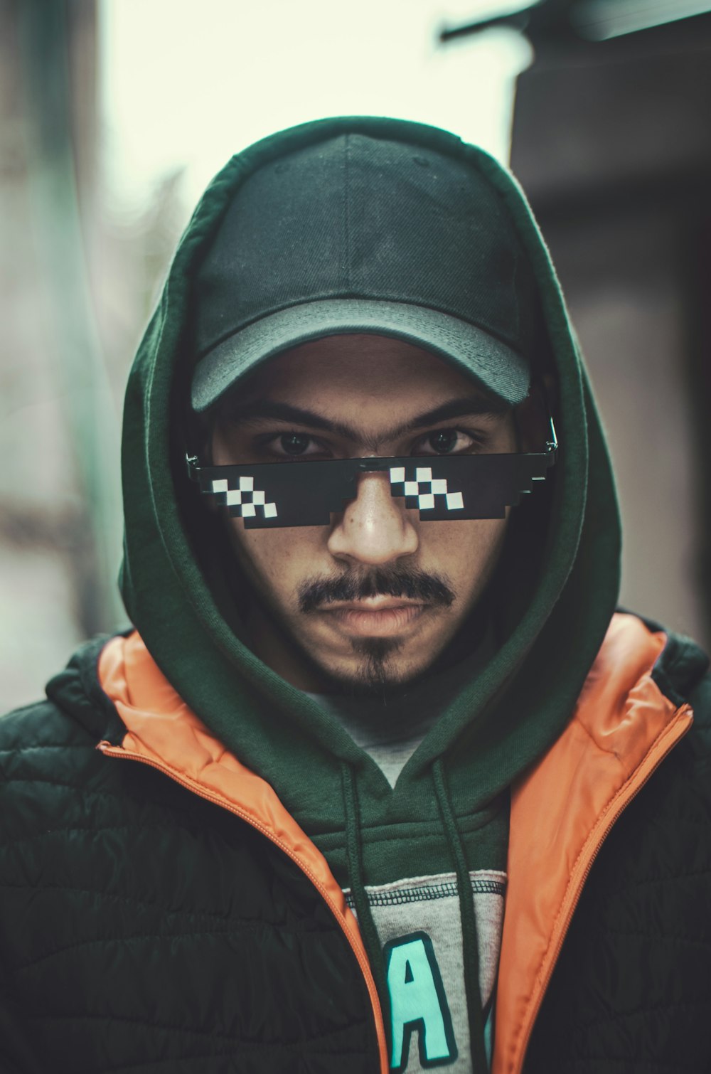 a man with a hoodie and a pair of glasses on his face