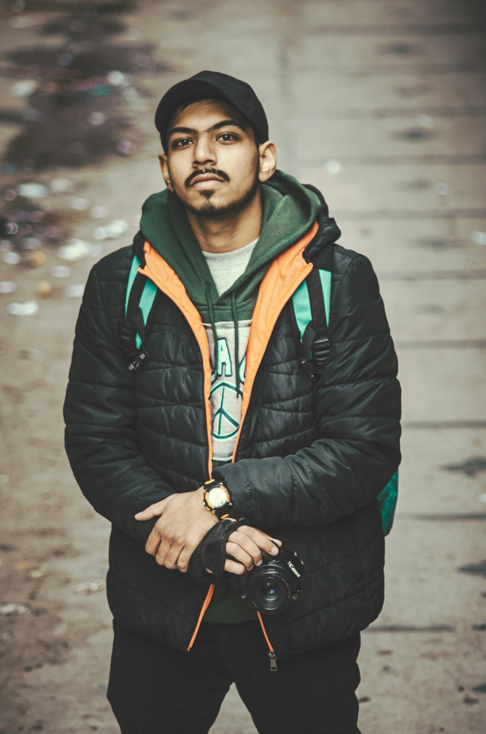 a man standing on a street with a camera