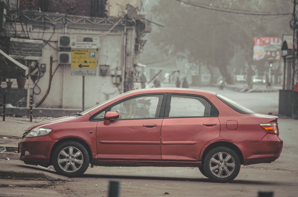 a red car parked on the side of the road