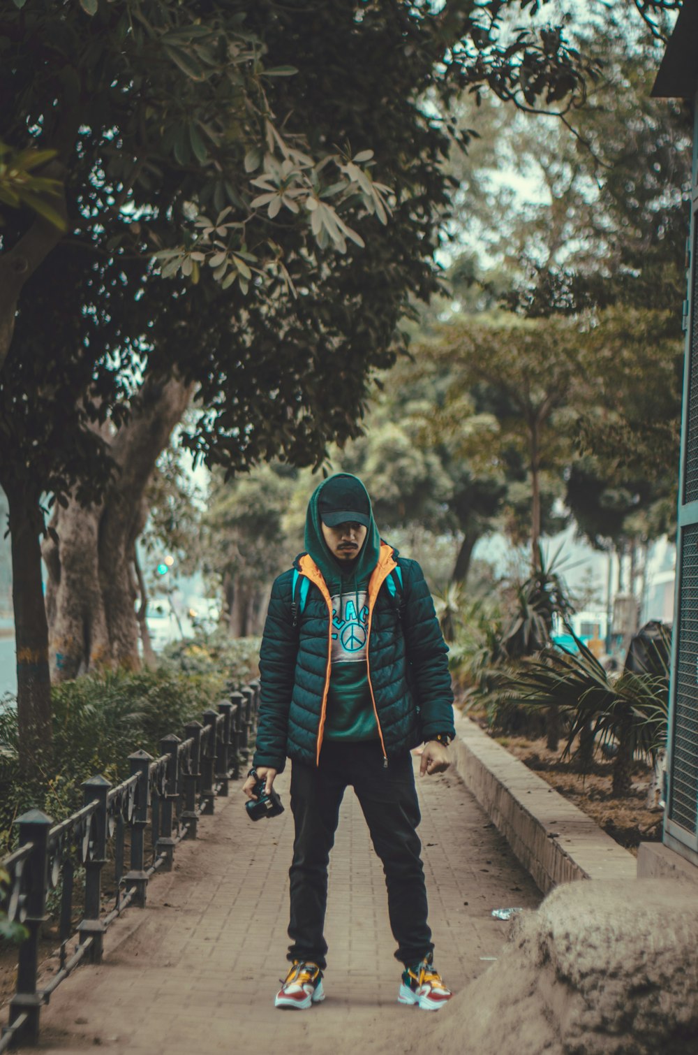 a young man riding a skateboard down a sidewalk