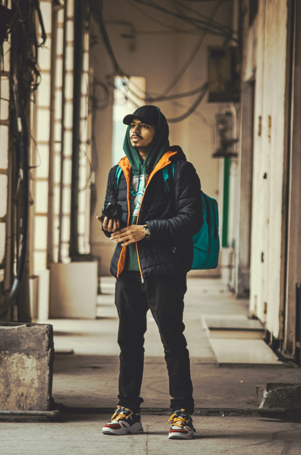 a man standing on a sidewalk looking at his cell phone