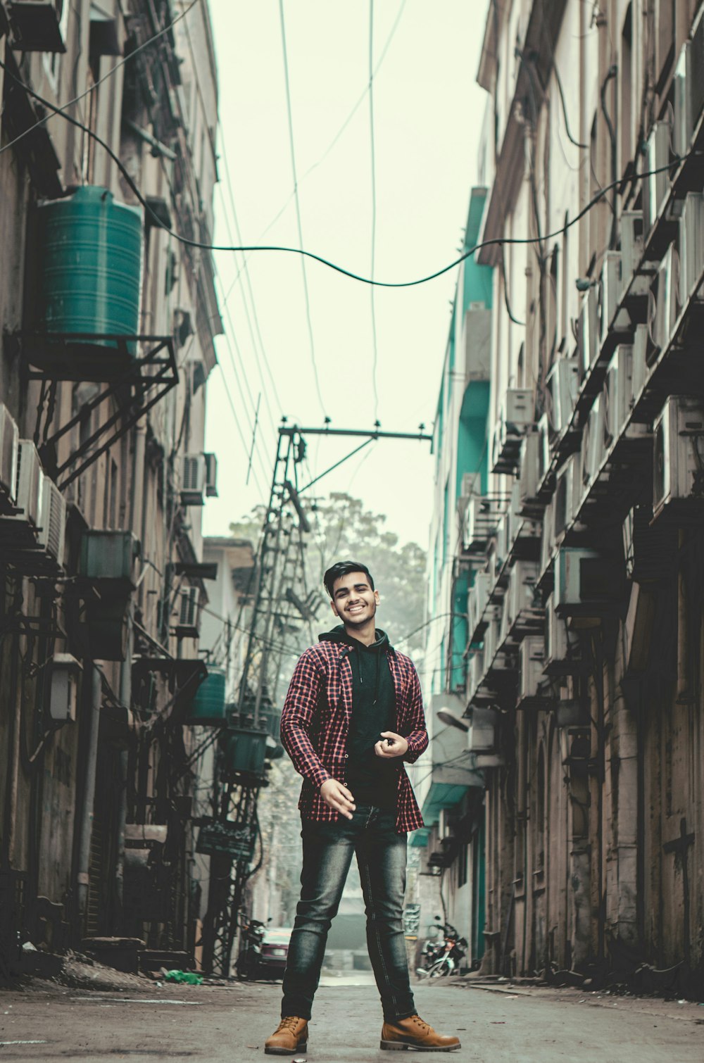 a man standing in the middle of an alley way