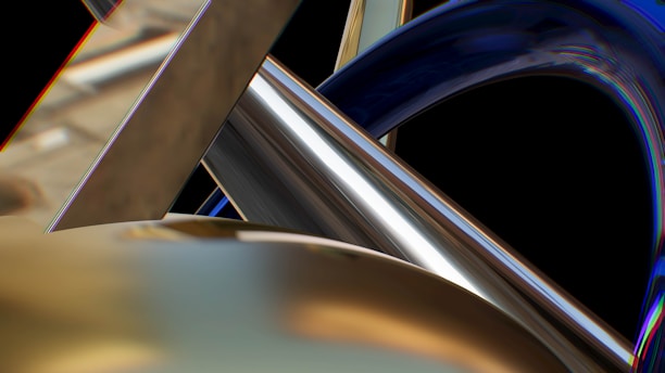 A composition of intertwined metallic structures featuring smooth and reflective surfaces. The curves and angles intersect to create an abstract and dynamic form against a dark background.