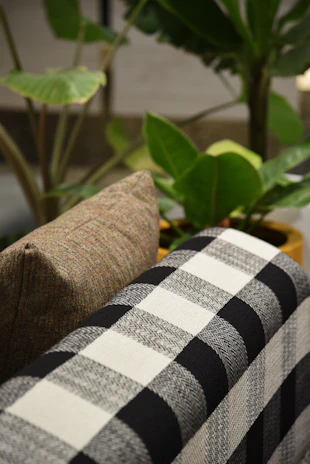 A close-up of outdoor bolster pillows that complement the curtains.