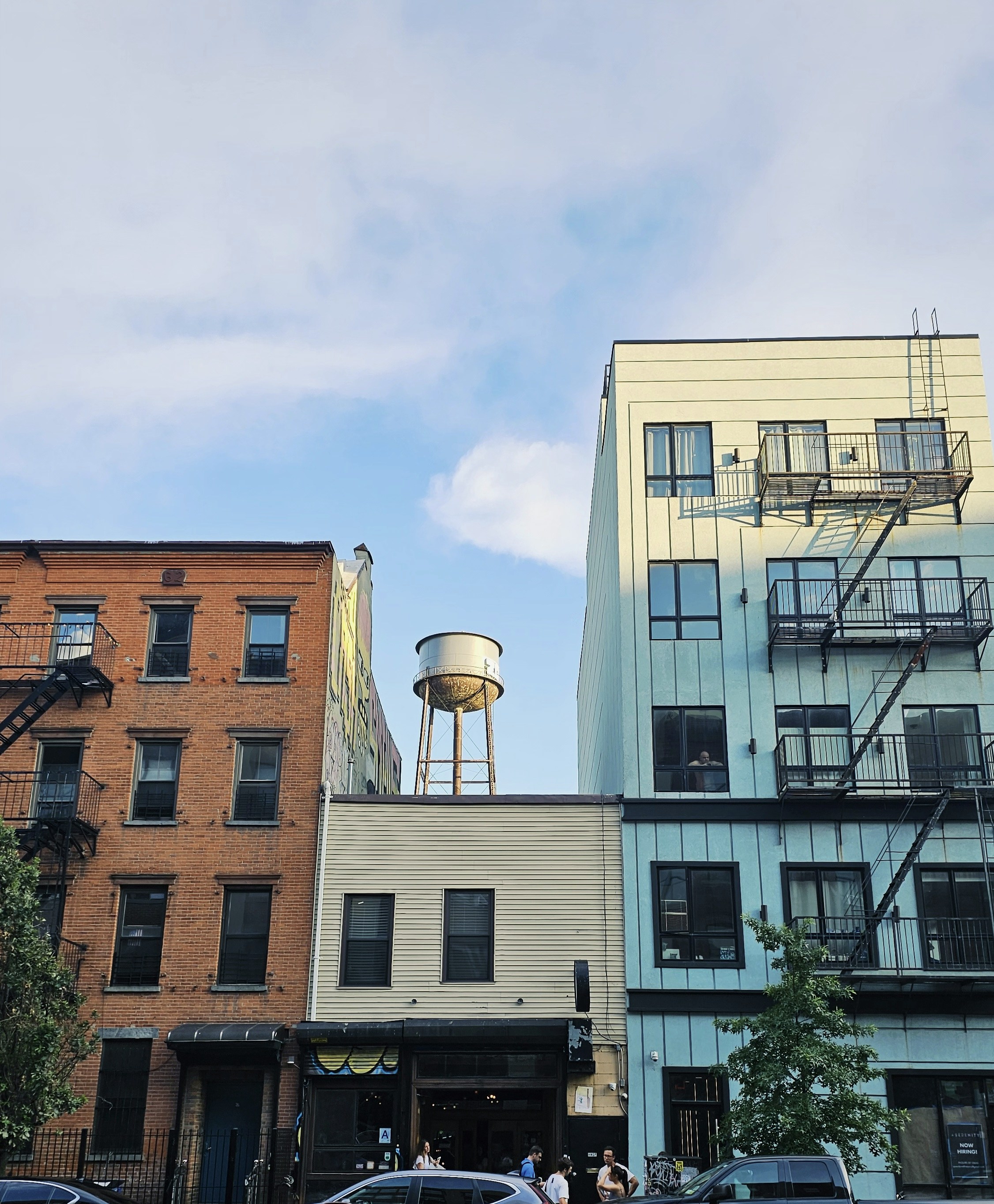 a group of cars parked in front of tall buildings