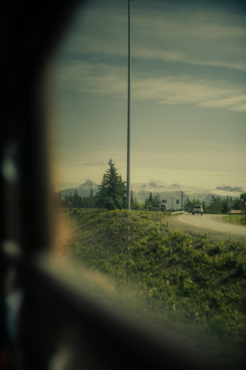 a view of a road from a vehicle window