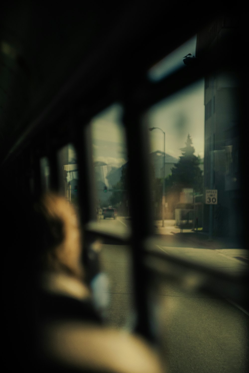a view of a street from a bus window