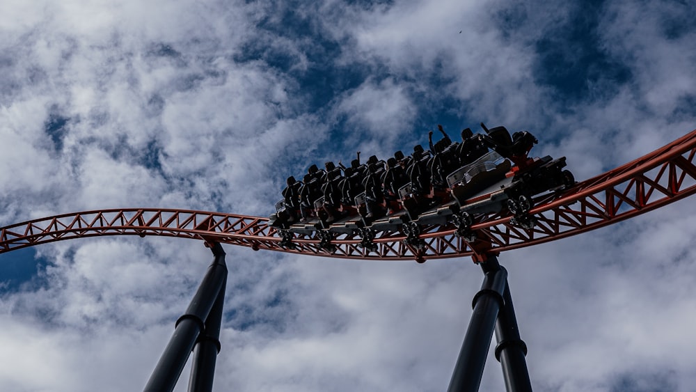 a roller coaster in the middle of a cloudy sky