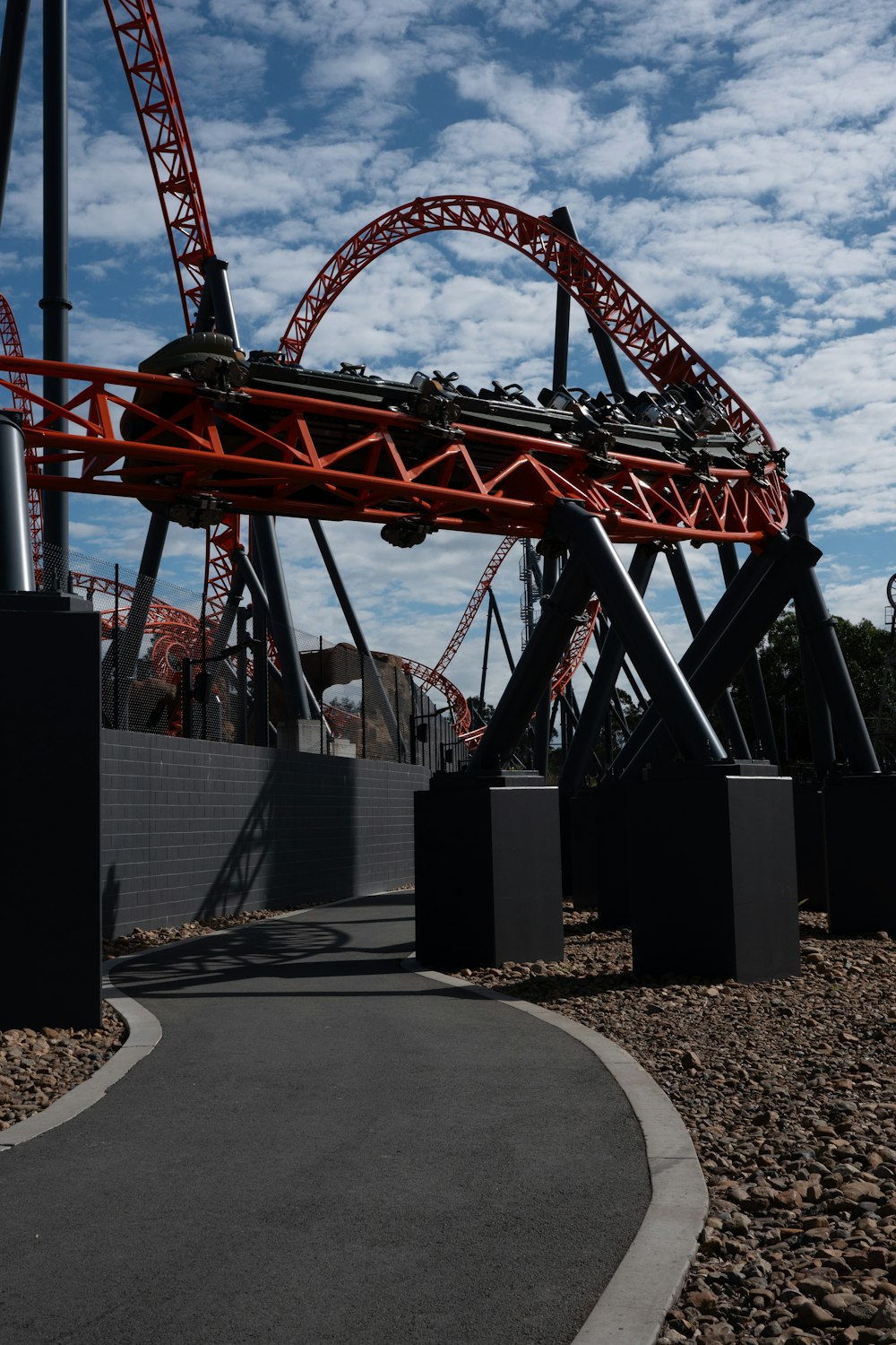 a roller coaster going down a hill on a cloudy day