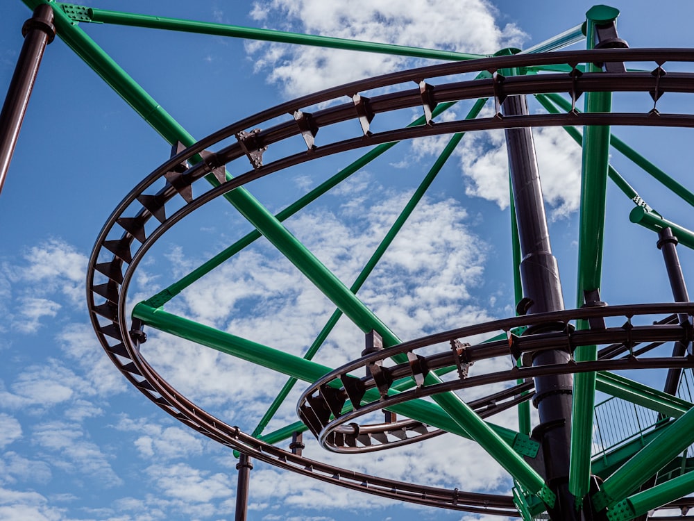 a close up of a roller coaster on a cloudy day