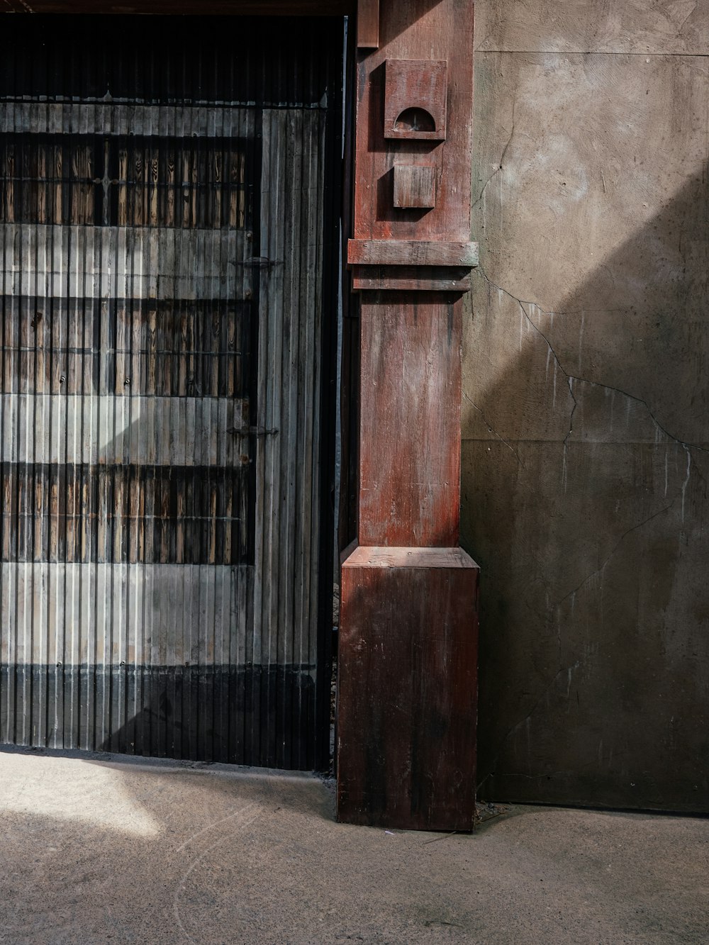 a tall wooden pole sitting next to a building