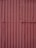 Corrugated metal sheets painted in a faded reddish-brown color with visible seams and texture. Each sheet is vertically aligned with visible rust spots and dents, giving a rugged, industrial appearance.