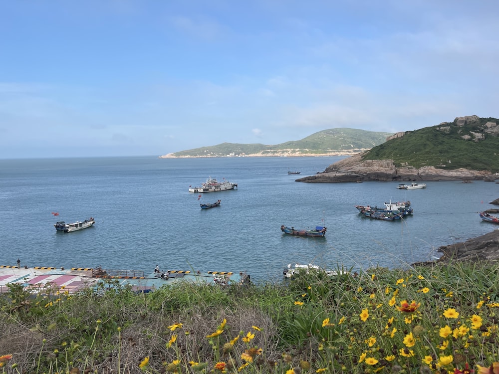 a group of boats floating on top of a large body of water