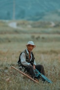 a man sitting in the middle of a field