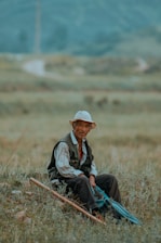 a man sitting in the middle of a field