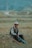a man sitting in the middle of a field