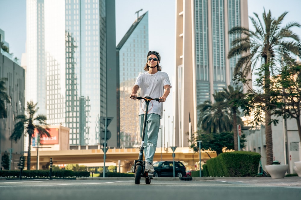 a man riding a scooter on a city street