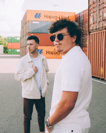 Handshake between two business people in front of shipping containers.