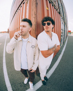 A candid photo of Yassin Papito at Mombasa port, engaged in discussion with colleagues near shipping containers.