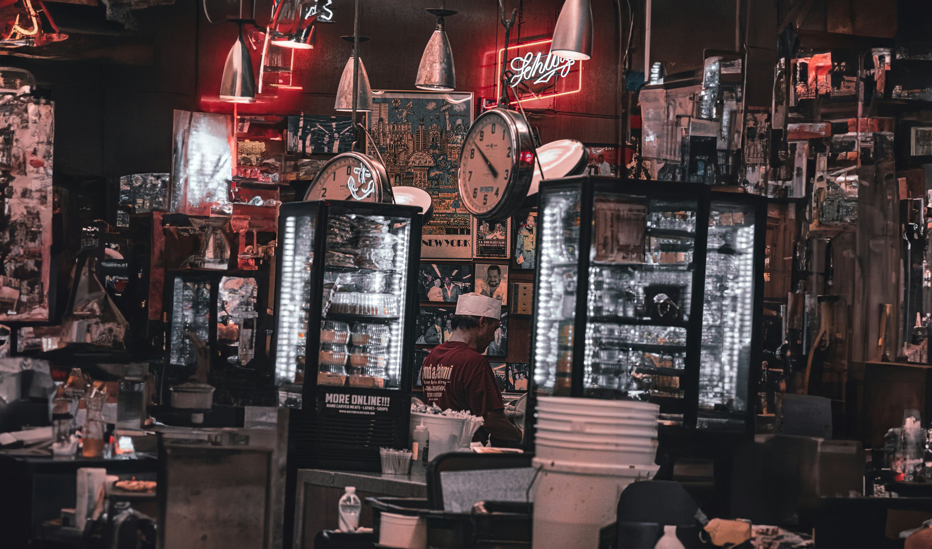 a man standing in a room filled with lots of clocks