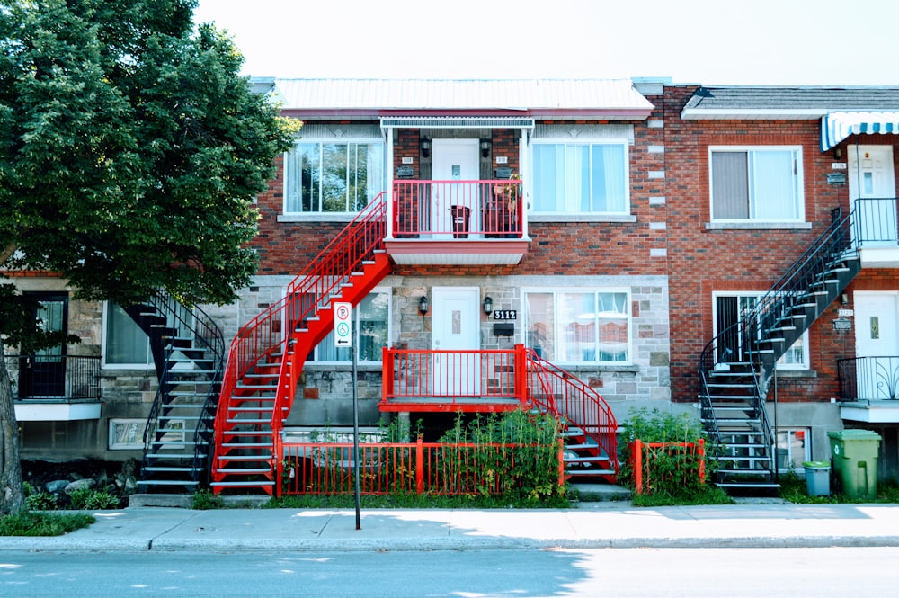 a red fire hydrant sitting in front of a brick building