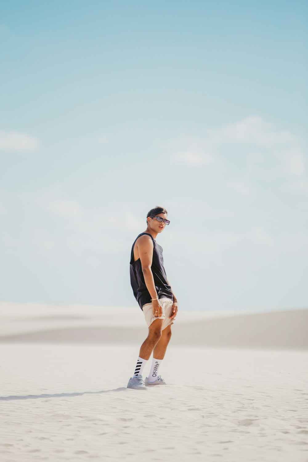 a man standing on top of a sandy beach