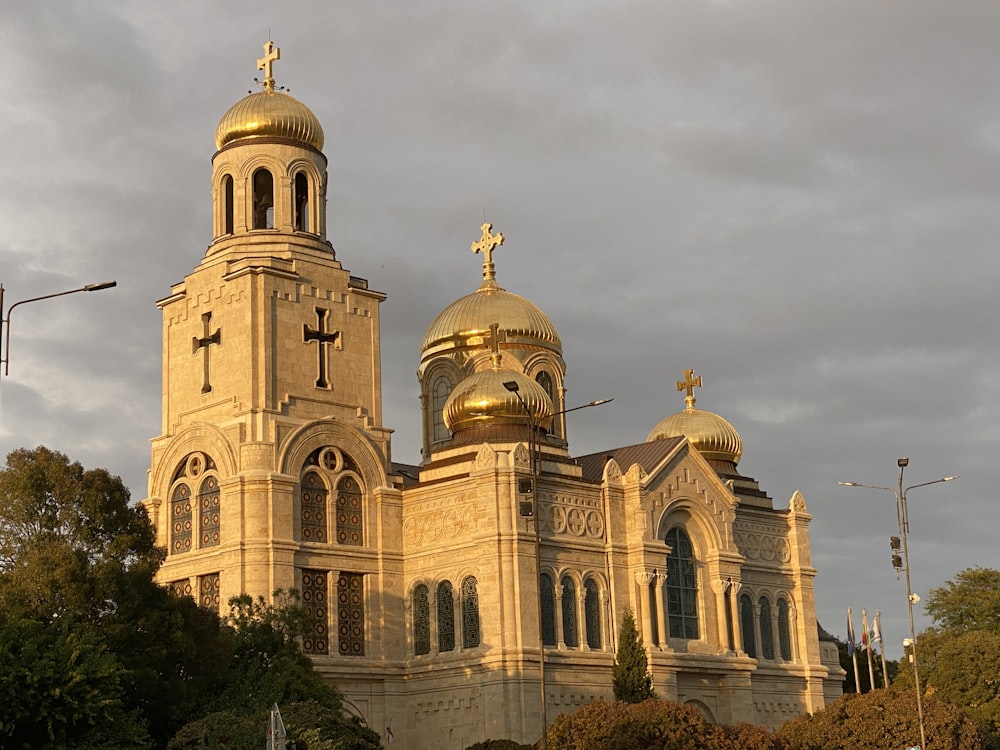 a church with a golden dome and cross on it