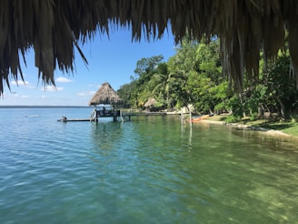 a body of water with a hut in the middle of it