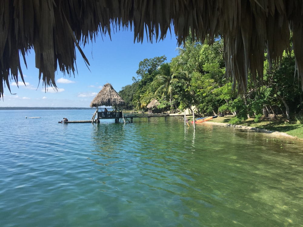 a body of water with a hut in the middle of it