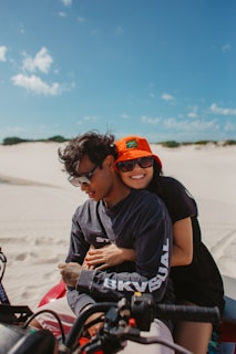 Couple enjoying a buggy ride on sandy trails surrounded by desert landscape