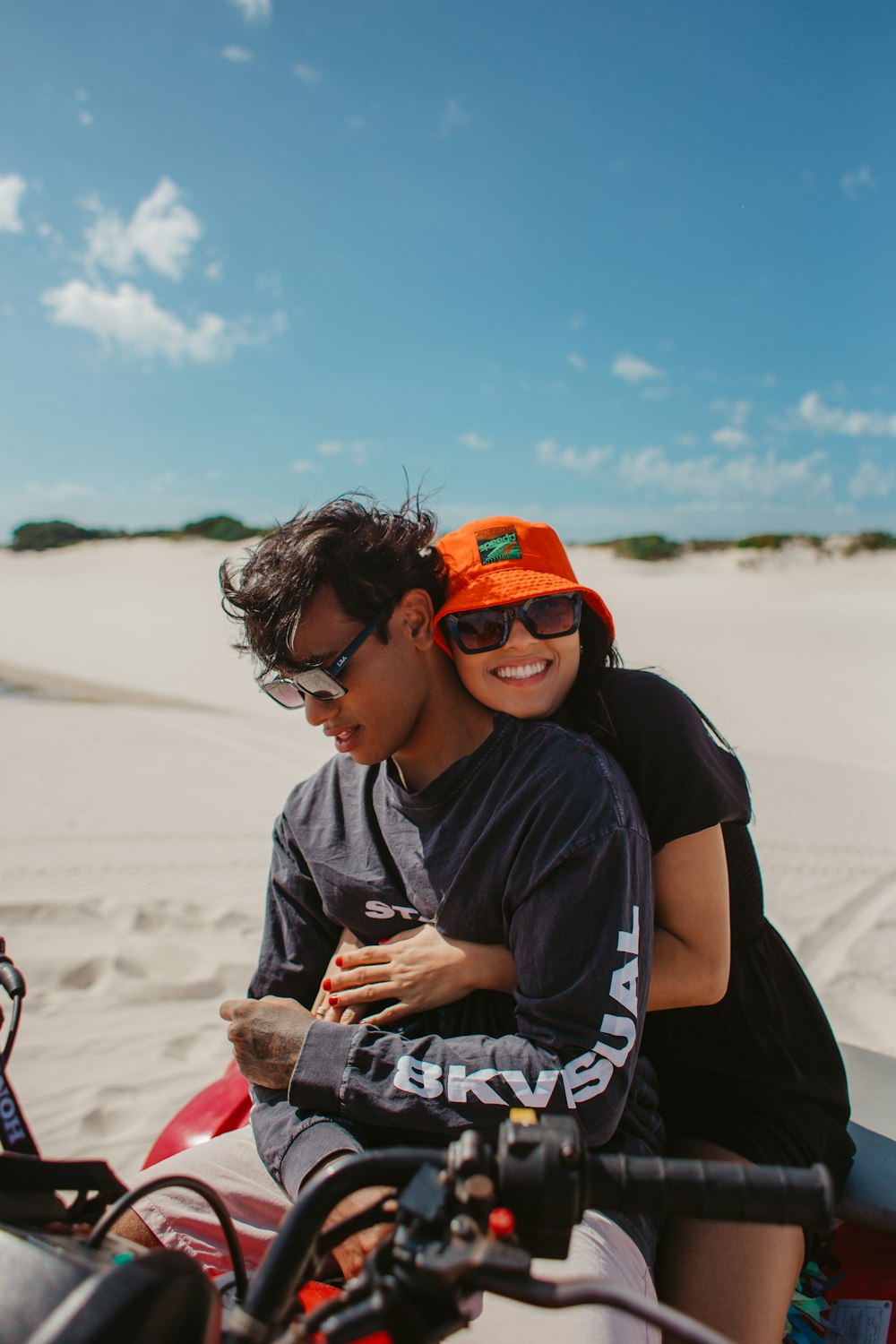 a man riding on the back of a motorcycle next to a woman